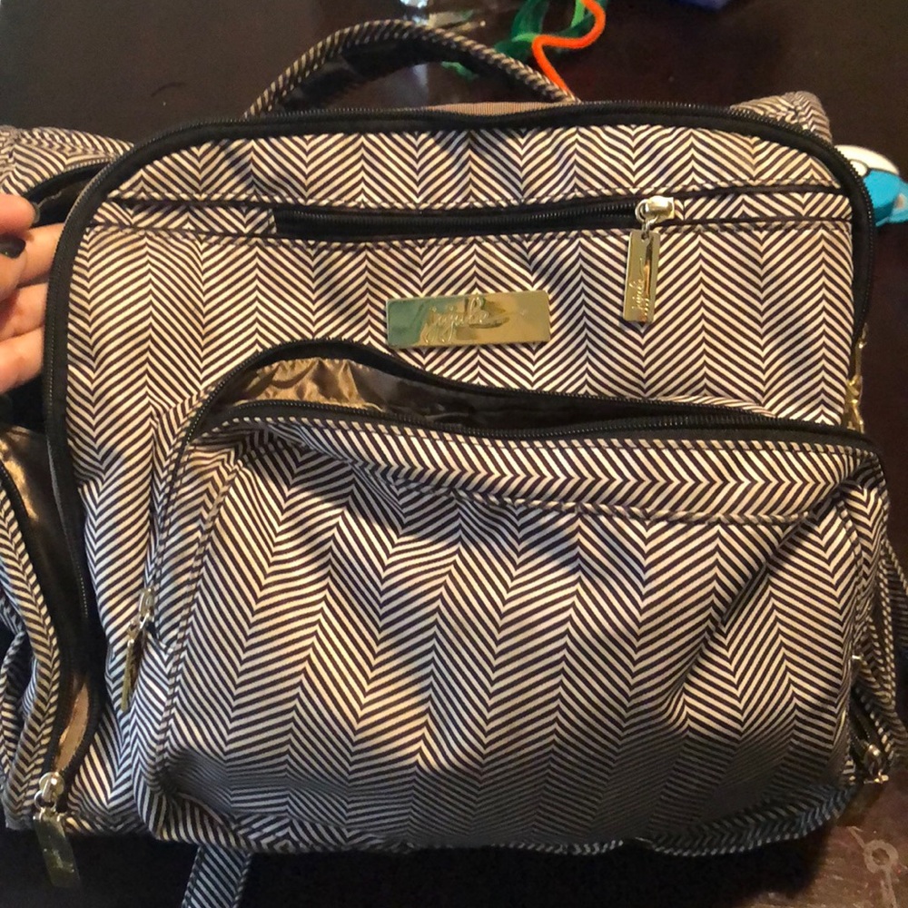 Jujube diaper bag backpack with changing pad